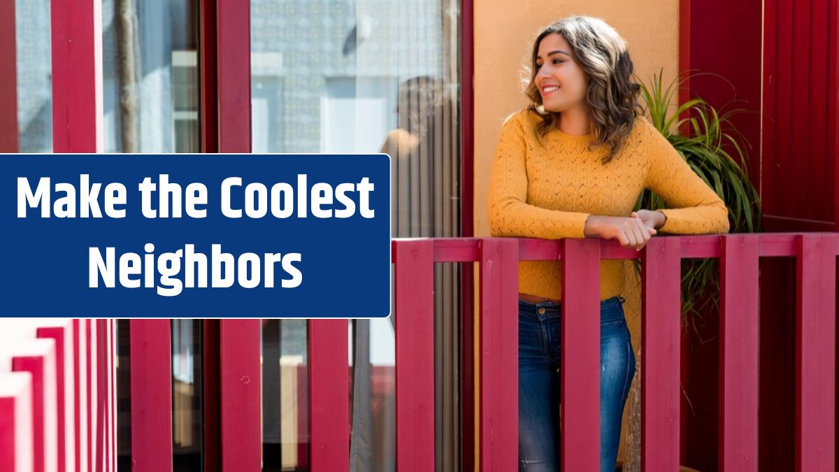 Smiling young woman standing by railing in balcony.