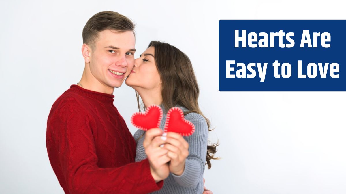 Young couple holding small hearts in hands.