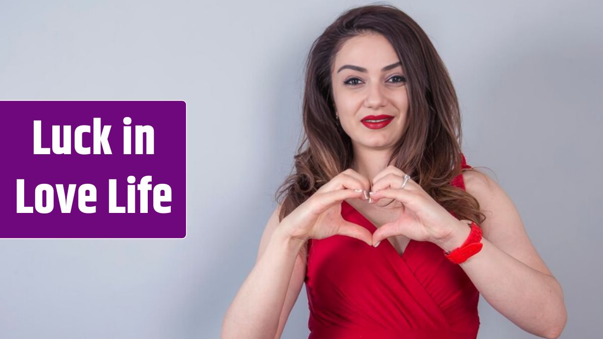 Photo of happy woman smiling and showing heart shape with hands.