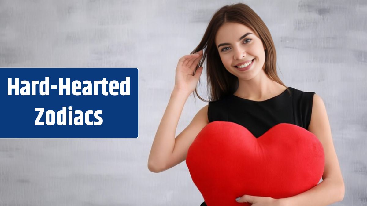 Romantic young woman with heartshaped pillow on light background.