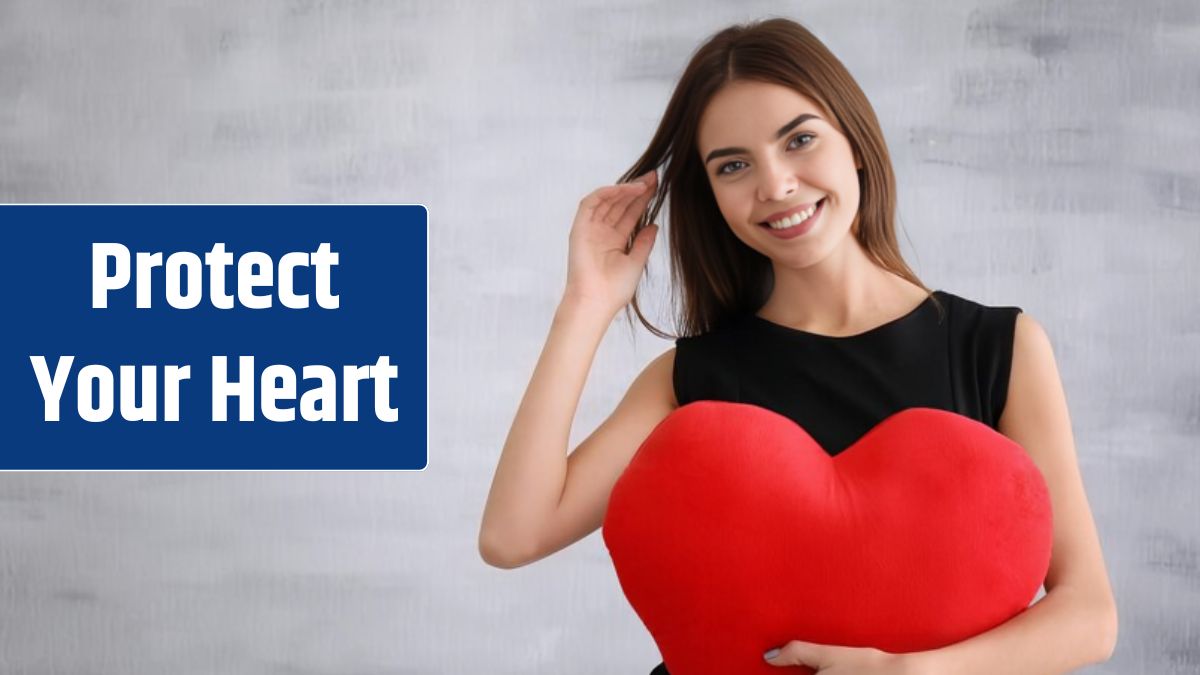 Romantic young woman with heartshaped pillow on light background.